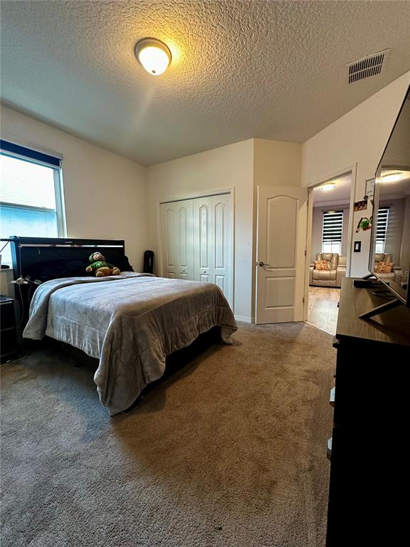 12351 Northover Loop Orlando, FL 32824 - Photo 47 of 58 a bedroom with a bed and a large mirror