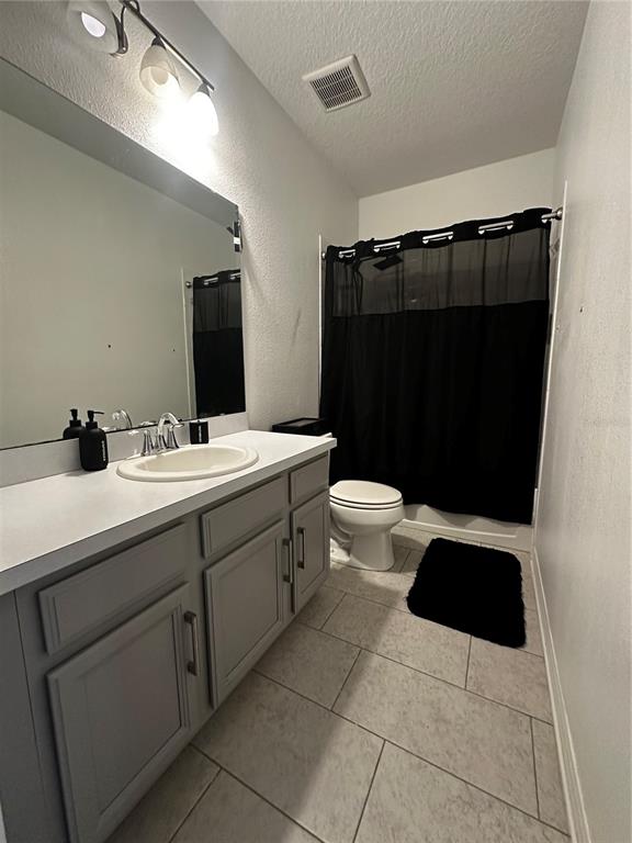 12351 Northover Loop Orlando, FL 32824 - Photo 48 of 58 a bathroom with a sink toilet and shower