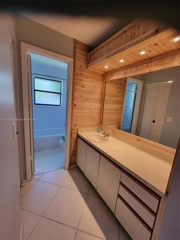 a bathroom with a double vanity sink and mirror