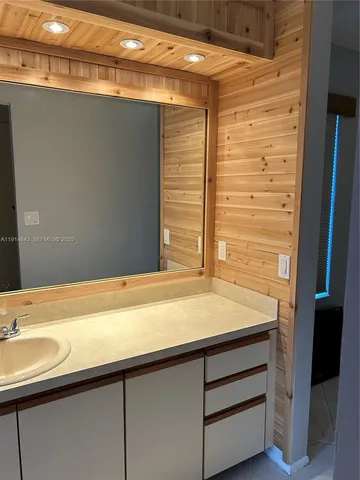 a bathroom with a double vanity sink and mirror