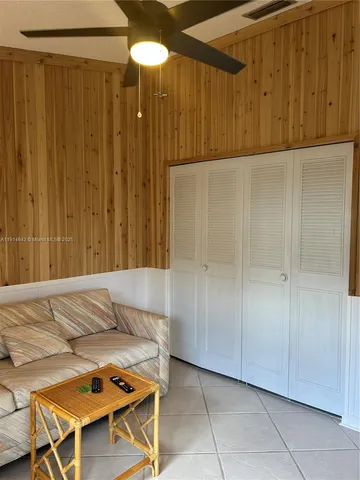 a bedroom with a bed and a table chair