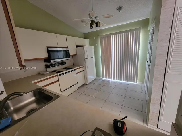 a kitchen with stainless steel appliances a stove a sink and a refrigerator