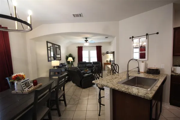 a kitchen with a sink refrigerator and cabinets
