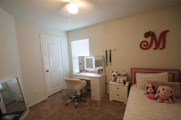 a bathroom with a sink a toilet and shower curtain