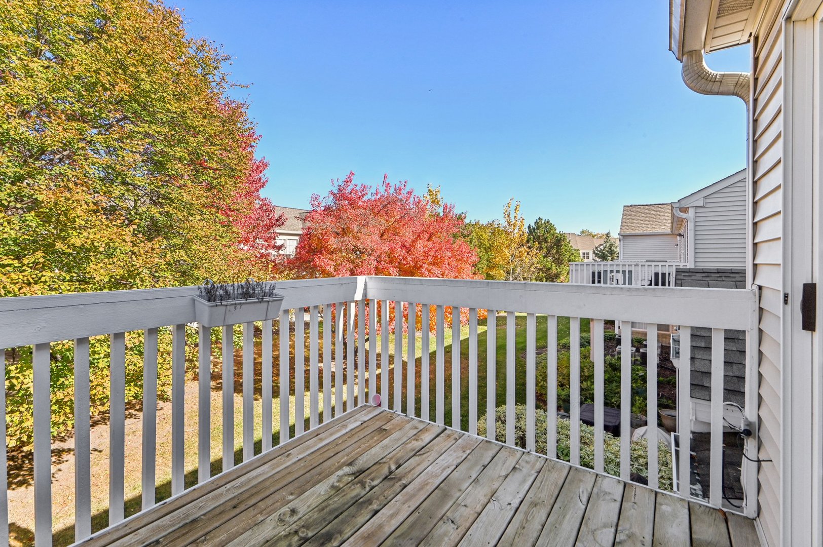 2227 Waterleaf Court, Unit 203 Naperville, IL 60564 - Photo 24 of 28 a balcony with wooden floor and fence