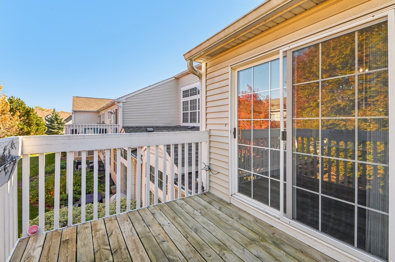 2227 Waterleaf Court, Unit 203 Naperville, IL 60564 - Photo 25 of 28 a view of a balcony with a floor to ceiling window and wooden floor
