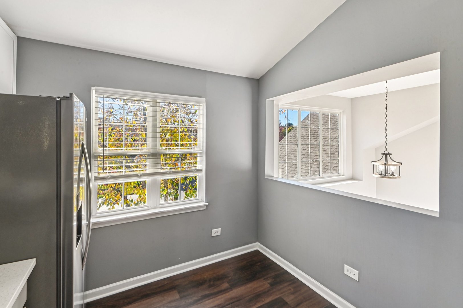 2227 Waterleaf Court, Unit 203 Naperville, IL 60564 - Photo 10 of 28 a view of an empty room with wooden floor and a window