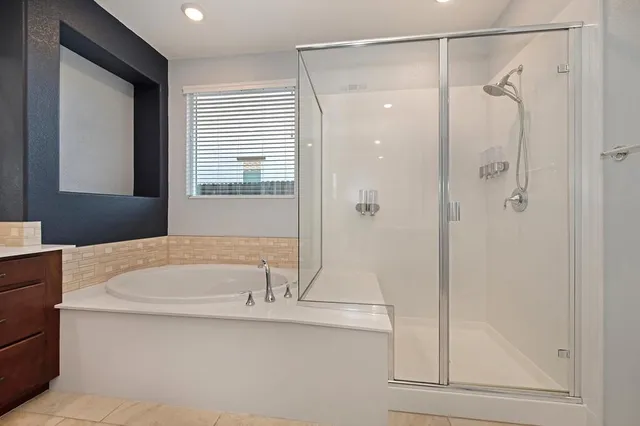 a bathroom with a bathtub and a shower