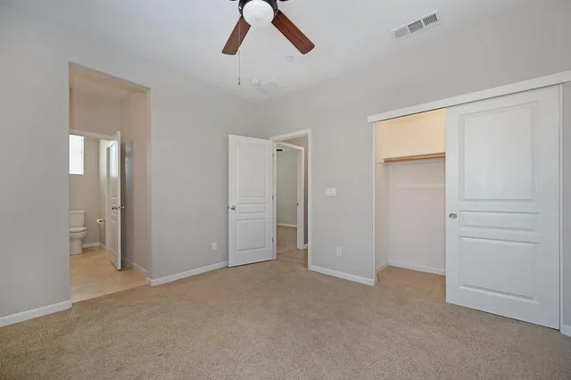 an empty room with windows and closet