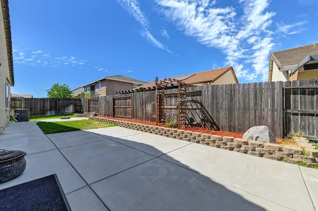 a backyard of a house with wooden floor and fence