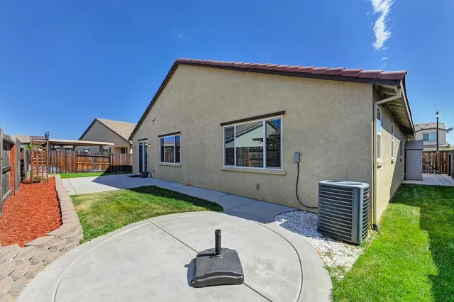 a view of a house with backyard and sitting area
