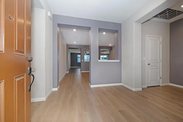 a view of a hallway with wooden floor