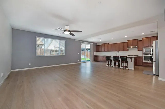 a view of a kitchen with furniture and wooden floor