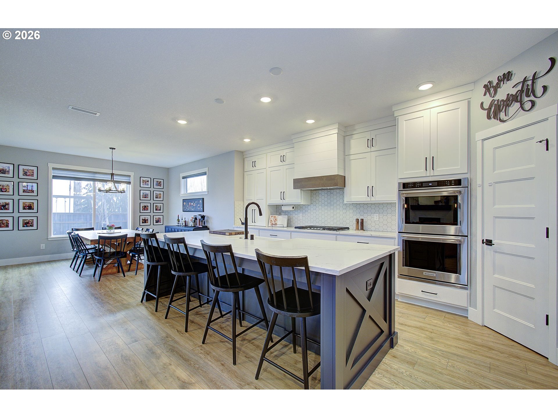 2831 Northeast 9th Avenue Battle Ground, WA 98604 - Photo 15 of 43 a open kitchen with stainless steel appliances kitchen island granite countertop a table chairs and a refrigerator