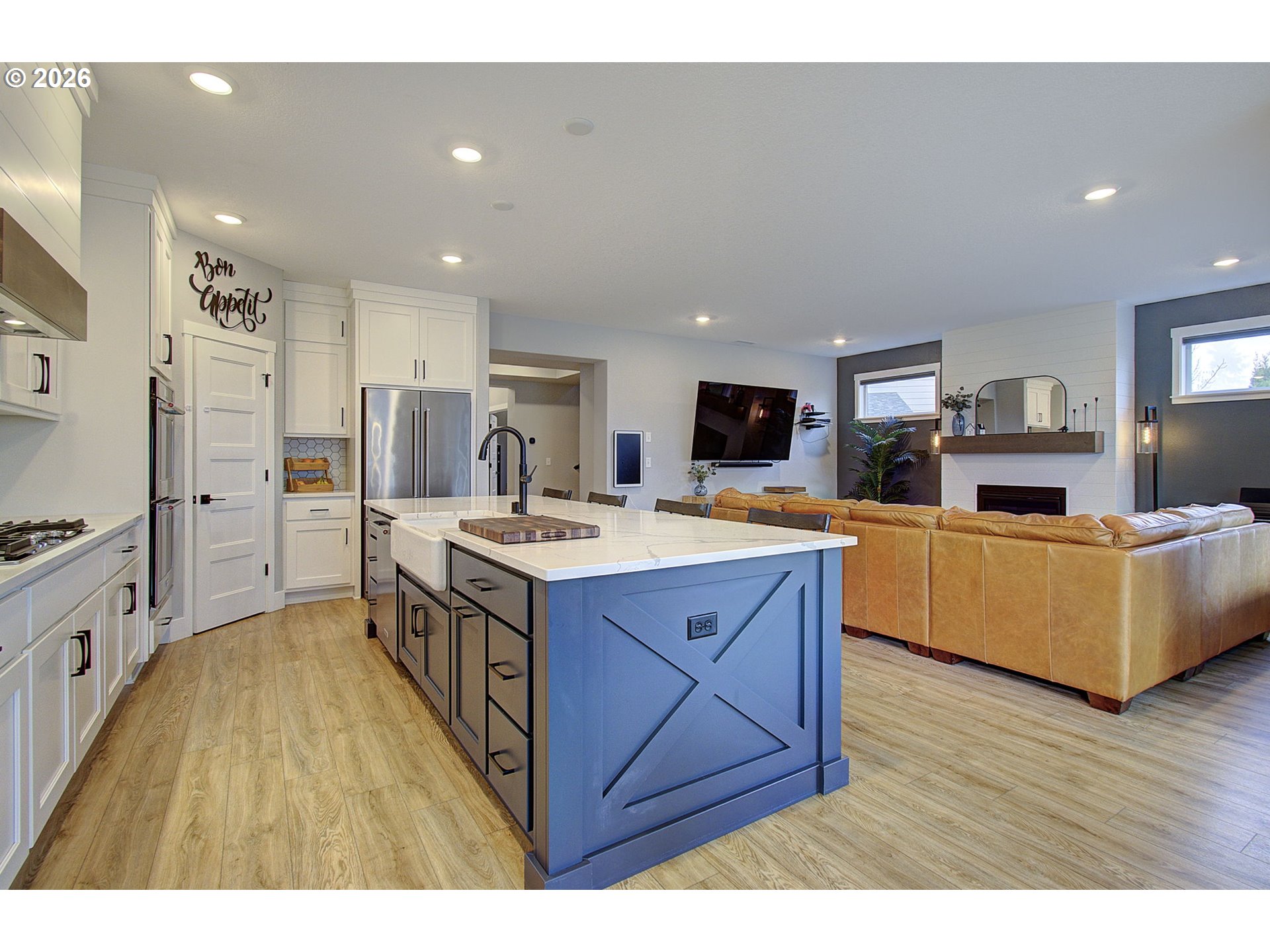 2831 Northeast 9th Avenue Battle Ground, WA 98604 - Photo 10 of 43 a kitchen with stainless steel appliances kitchen island granite countertop a stove a sink dishwasher and a refrigerator with wooden floor
