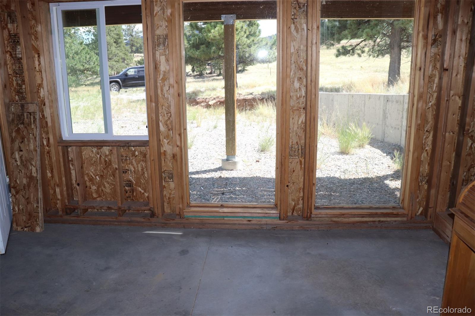 2026 Singletree Road Hartsel, CO 80449 - Photo 14 of 24 a view of an empty room with large windows