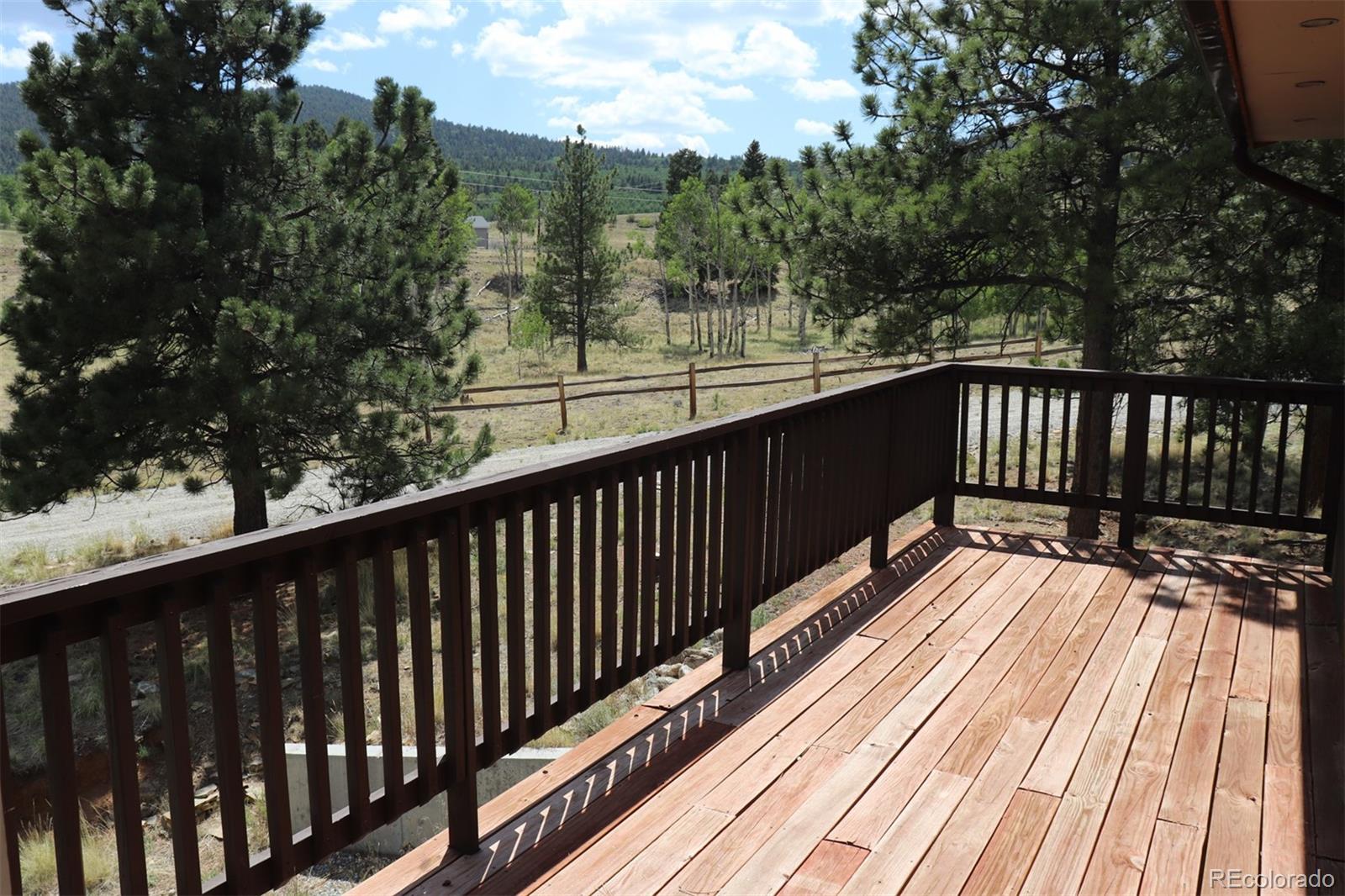 2026 Singletree Road Hartsel, CO 80449 - Photo 20 of 24 a view of balcony with wooden floor and fence