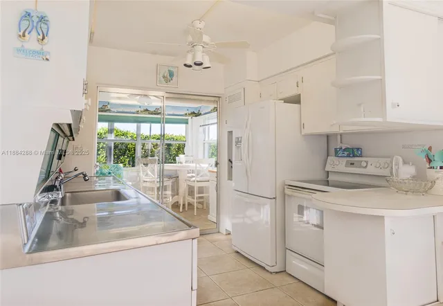 a kitchen with a sink stove and refrigerator