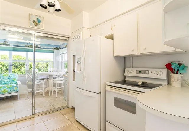 a kitchen with a stove and white cabinets