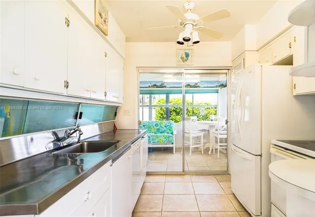 a kitchen with a sink and refrigerator