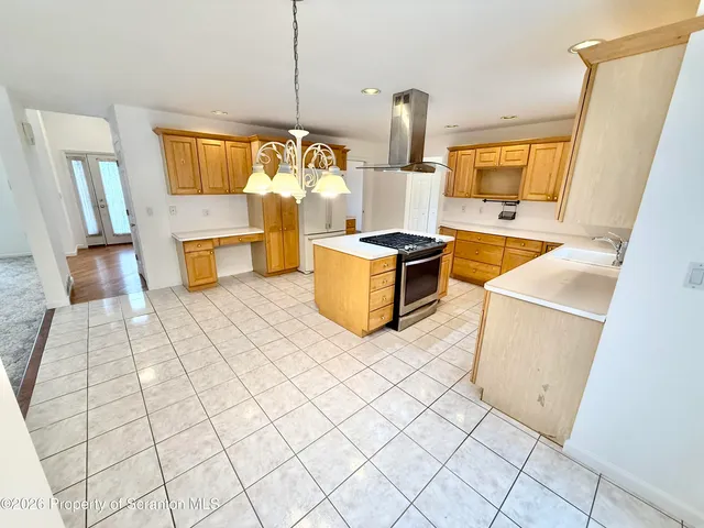 a view of a house with wooden deck and furniture