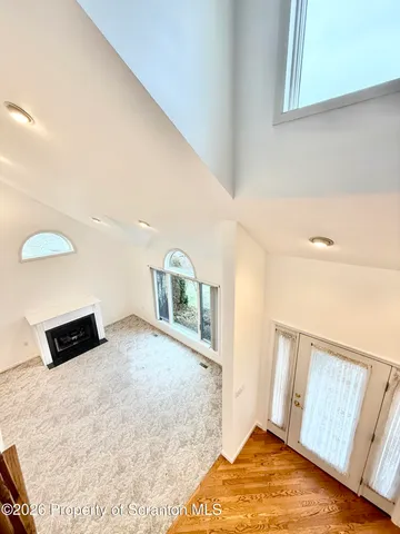 a view of an empty room with a fireplace