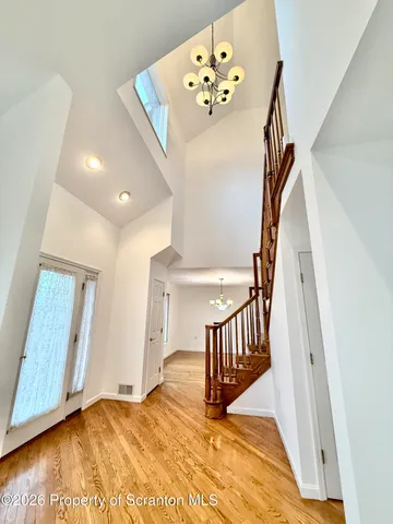 a view of entryway and hall with wooden floor