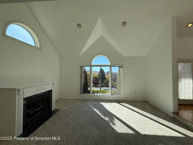 a view of empty room with window and fireplace