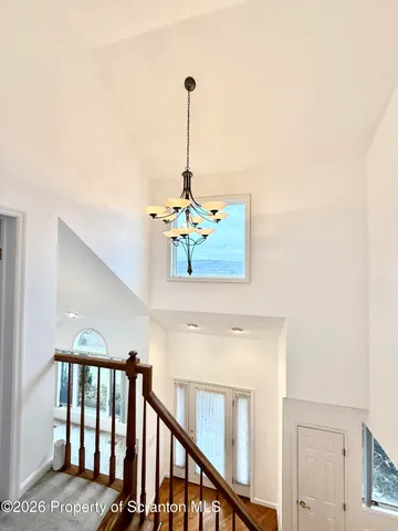 an empty room with a ceiling fan and a window