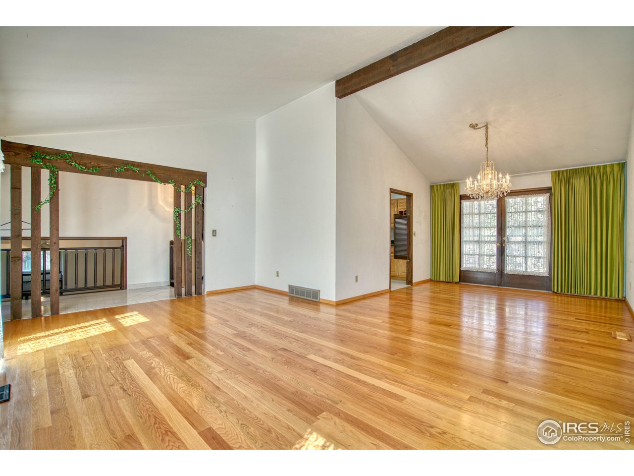 577 Blackhawk Road Boulder, CO 80303 - Photo 5 of 34 Living room and dining room with vaulted ceilings and wood beam