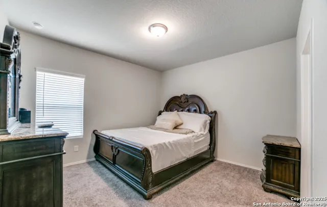 a bedroom with a bed and dresser