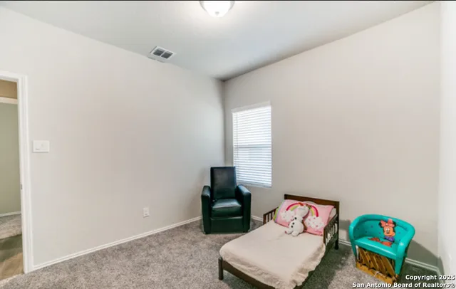 a bathroom with a sink a toilet and shower curtain