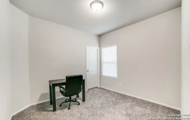 a room that has a window and a chair in it