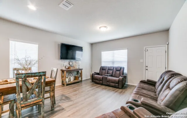a living room with fireplace furniture and a flat screen tv