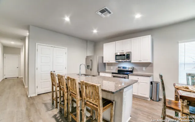 a kitchen with a sink stove and cabinets