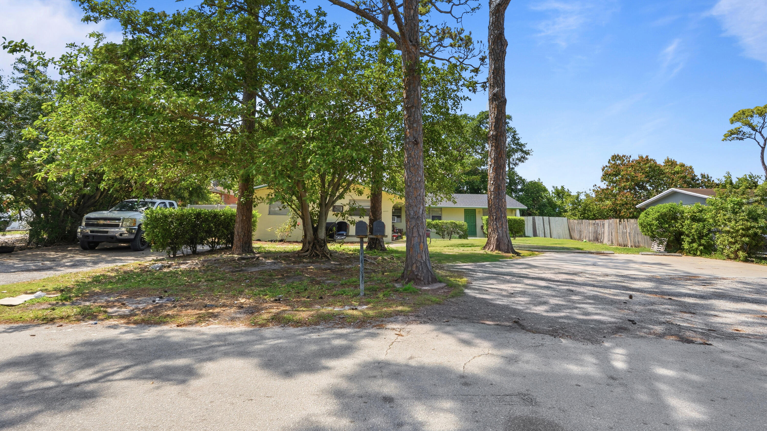 4453 Stevens Road Lake Worth Beach, FL 33461 - Photo 24 of 67 a view of a yard with a house in the background
