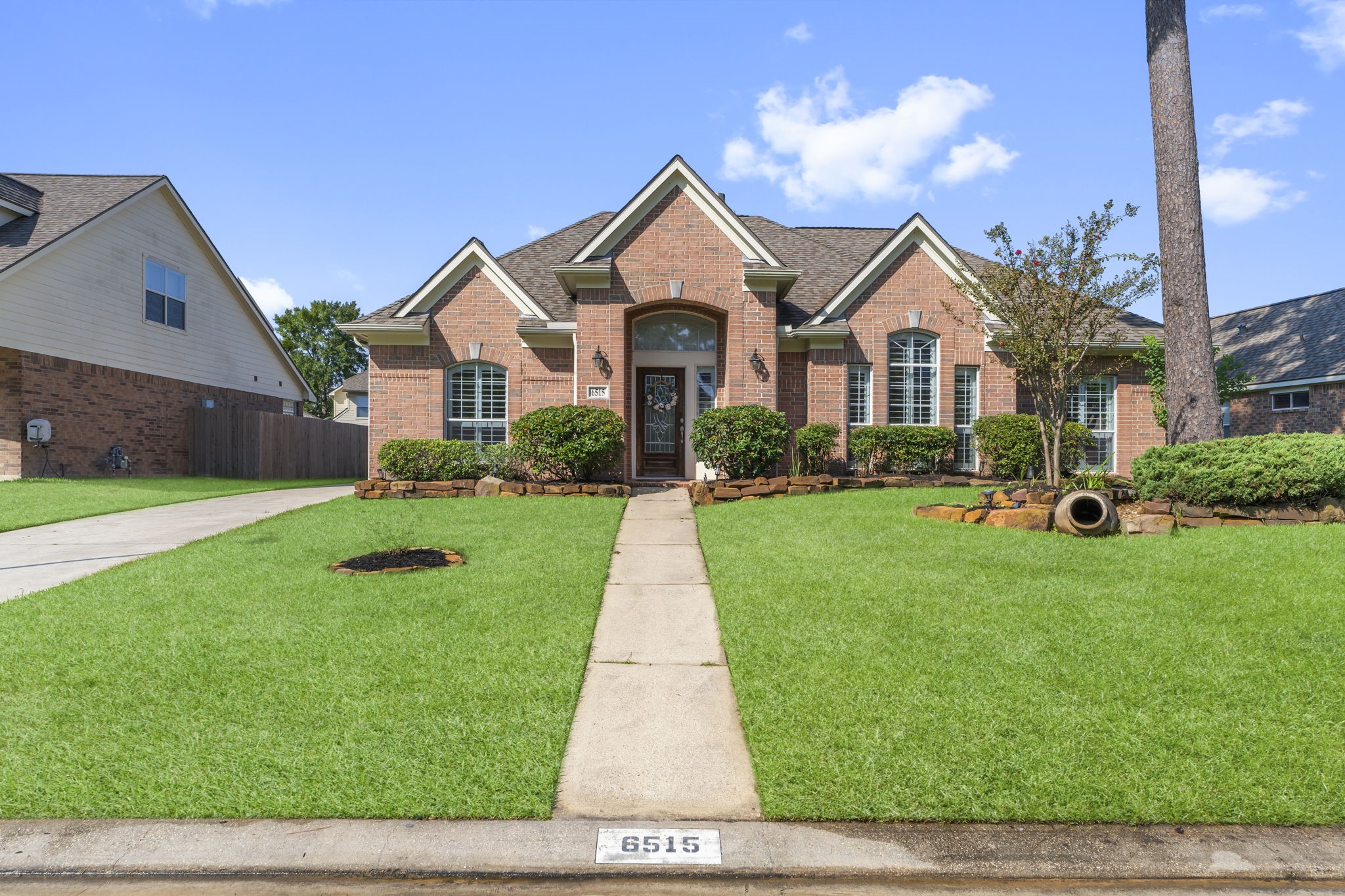 6515 Pine Arrow Court Spring, TX 77389 - Photo 2 of 31 a front view of a house with a yard and garage