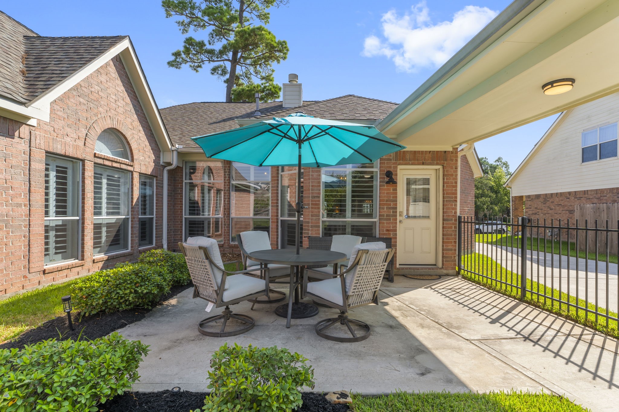 6515 Pine Arrow Court Spring, TX 77389 - Photo 23 of 31 a view of a patio with a table and chairs under an umbrella