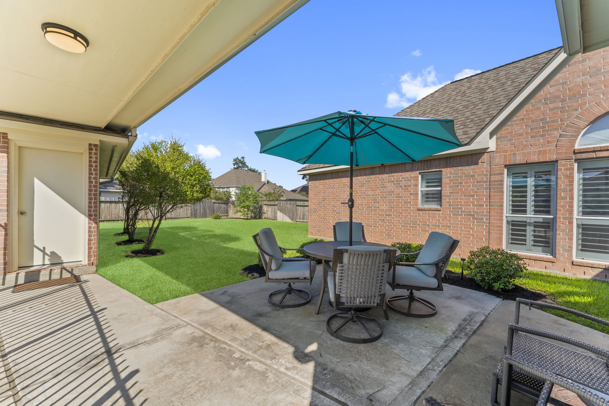 6515 Pine Arrow Court Spring, TX 77389 - Photo 24 of 31 a view of a patio with table and chairs under an umbrella