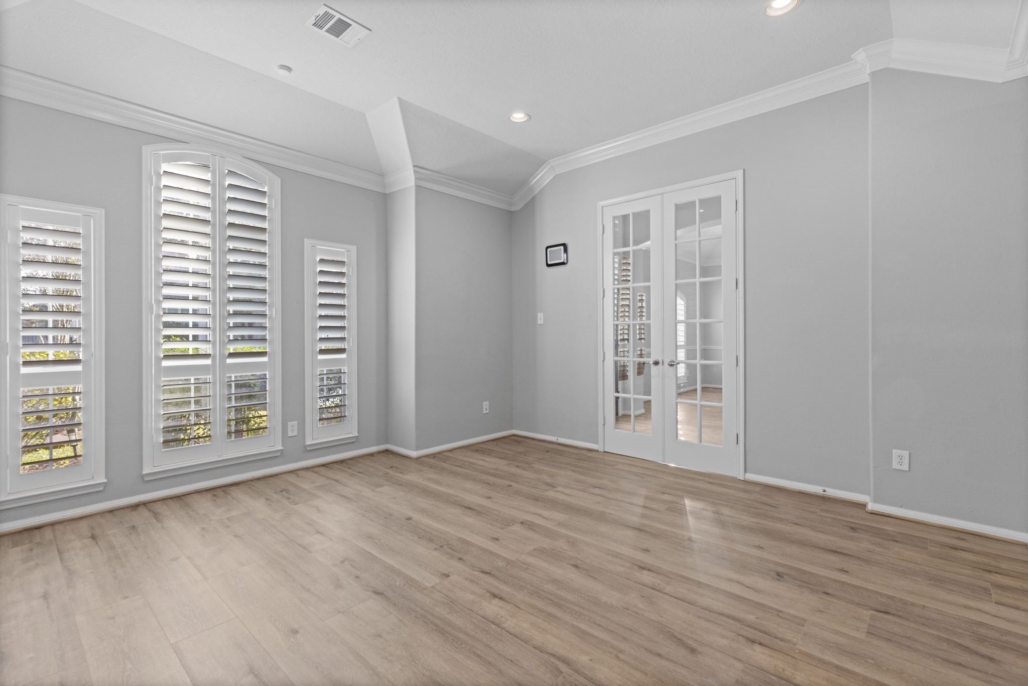 6515 Pine Arrow Court Spring, TX 77389 - Photo 6 of 31 a view of an empty room with wooden floor and a window