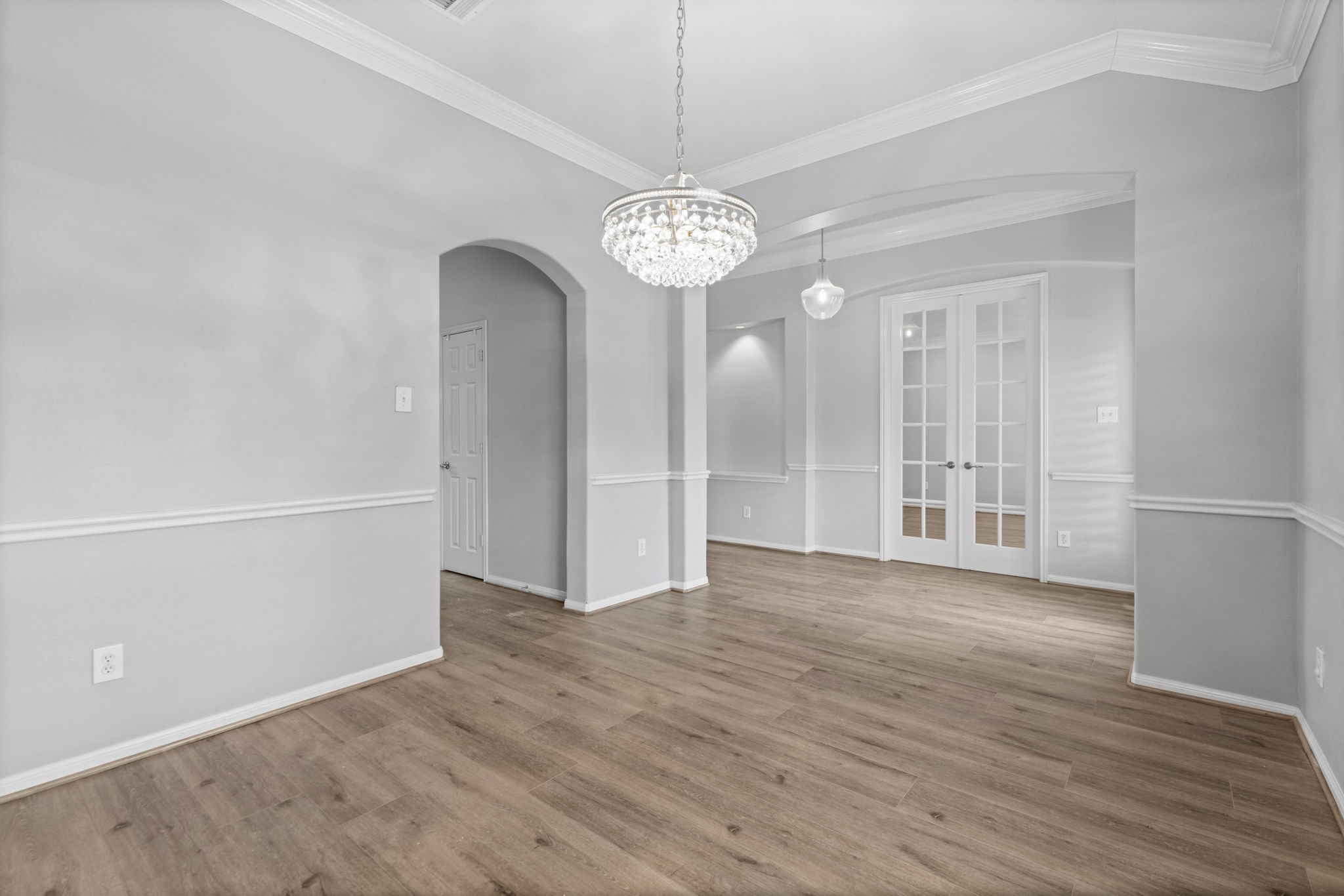 6515 Pine Arrow Court Spring, TX 77389 - Photo 7 of 31 a view of an empty room with wooden floor and a chandelier