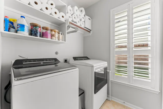 a view of a patio with a table and chairs under an umbrella