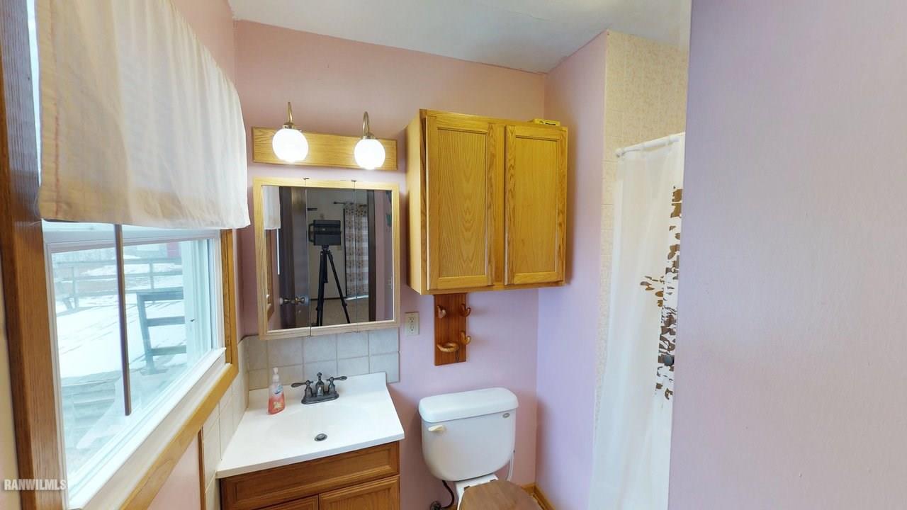 11280 Benson Road Lanark, IL 61046 - Photo 14 of 20 a bathroom with a sink toilet and mirror