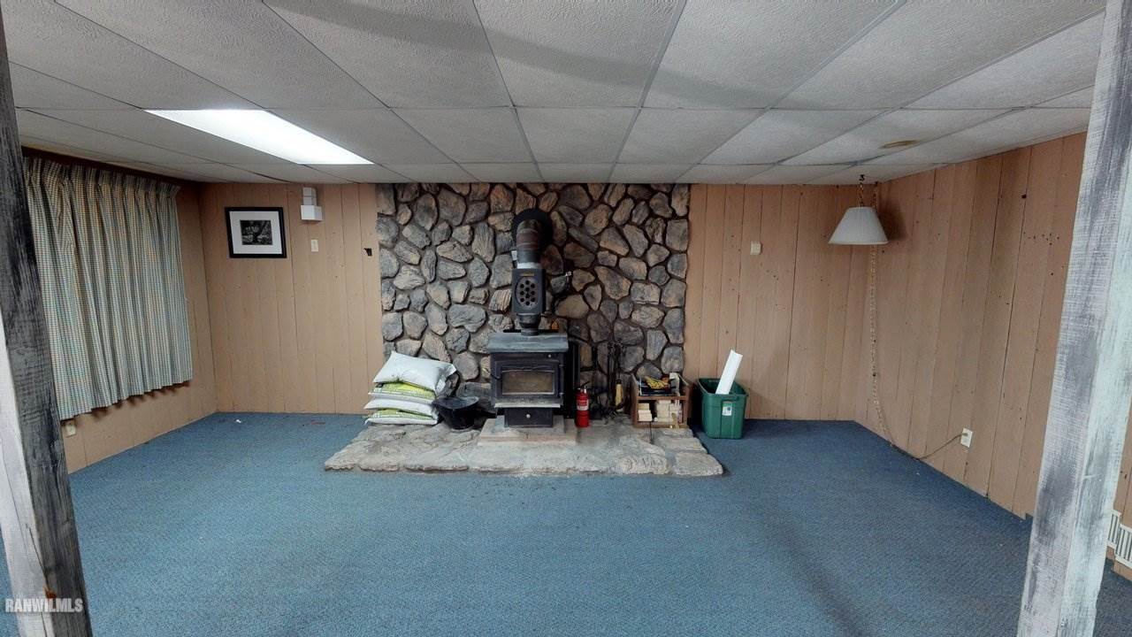 11280 Benson Road Lanark, IL 61046 - Photo 18 of 20 an empty room with a fireplace and painted walls