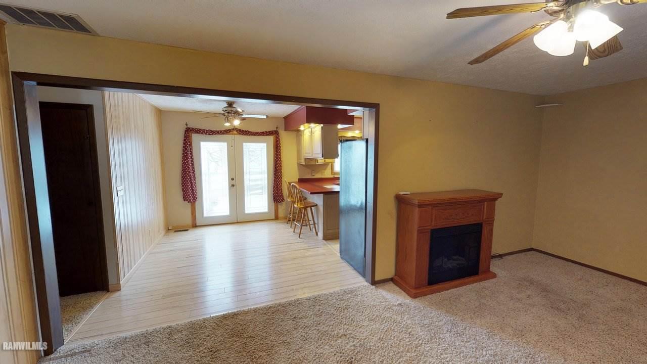 11280 Benson Road Lanark, IL 61046 - Photo 5 of 20 a view of a livingroom with an empty space and a fireplace