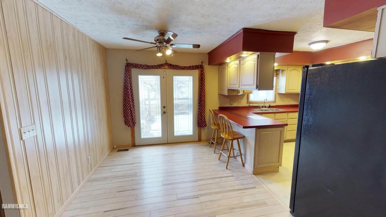 11280 Benson Road Lanark, IL 61046 - Photo 7 of 20 a view of a dining room with furniture window and wooden floor