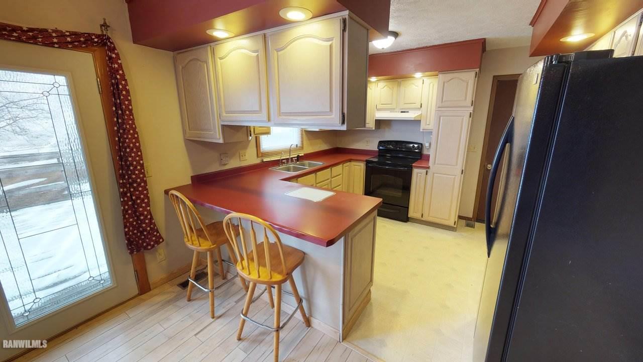 11280 Benson Road Lanark, IL 61046 - Photo 8 of 20 a kitchen with refrigerator and window