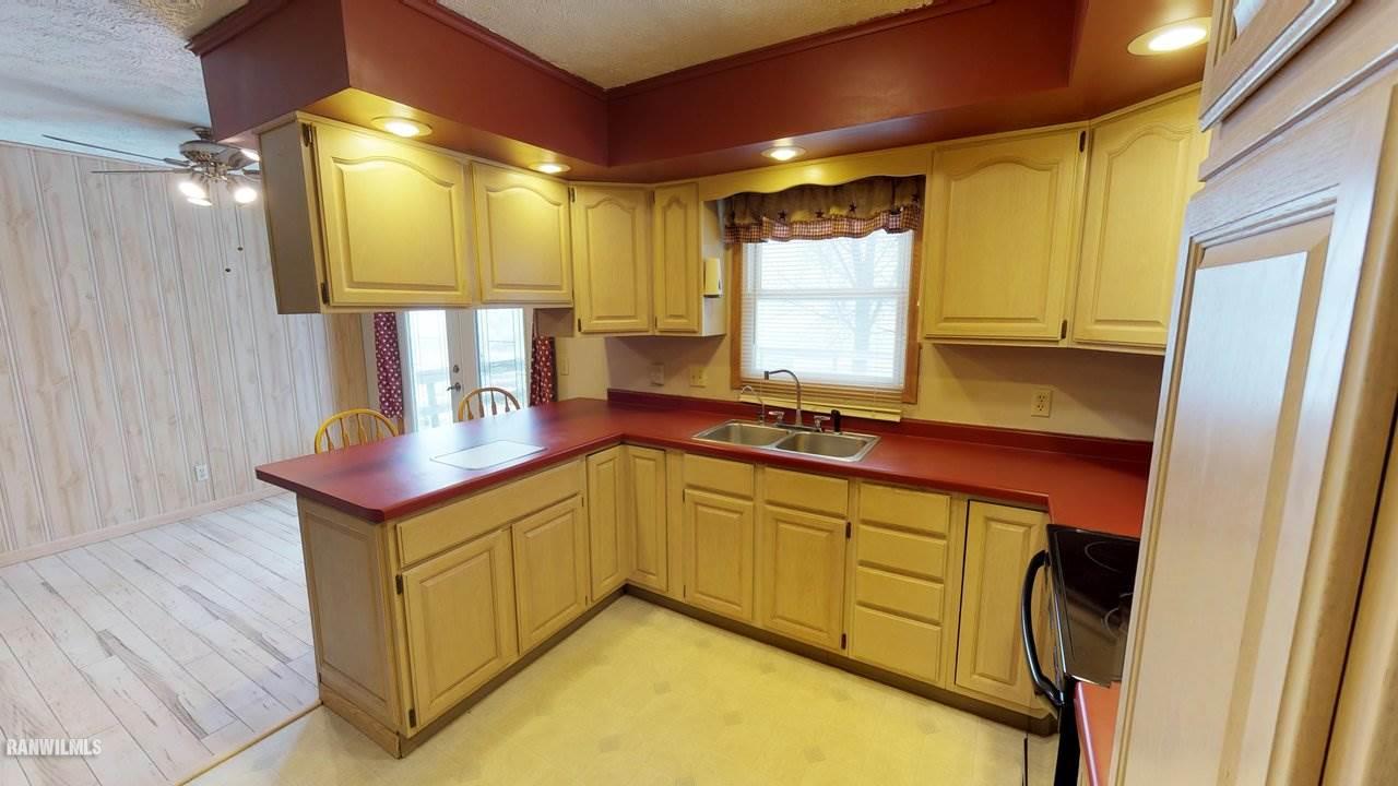11280 Benson Road Lanark, IL 61046 - Photo 9 of 20 a kitchen with stainless steel appliances granite countertop a sink and a refrigerator
