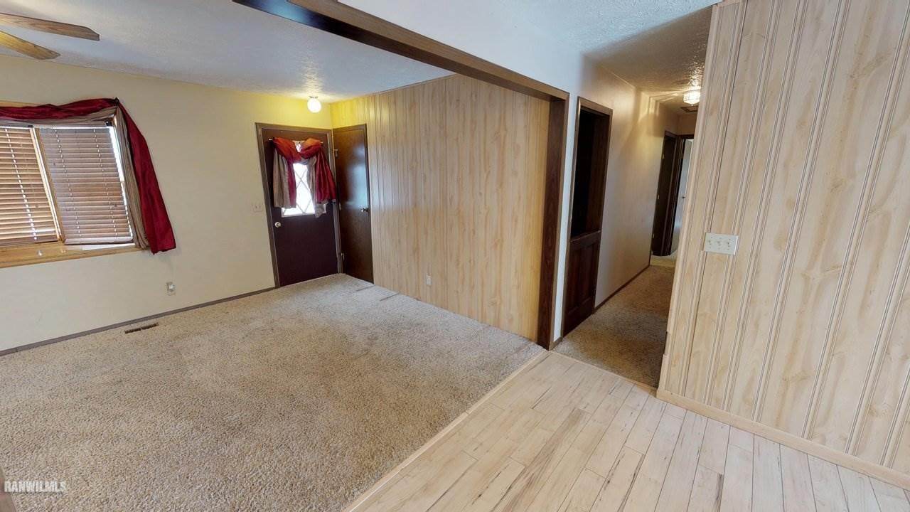 11280 Benson Road Lanark, IL 61046 - Photo 10 of 20 a view of hallway with window and wooden floor