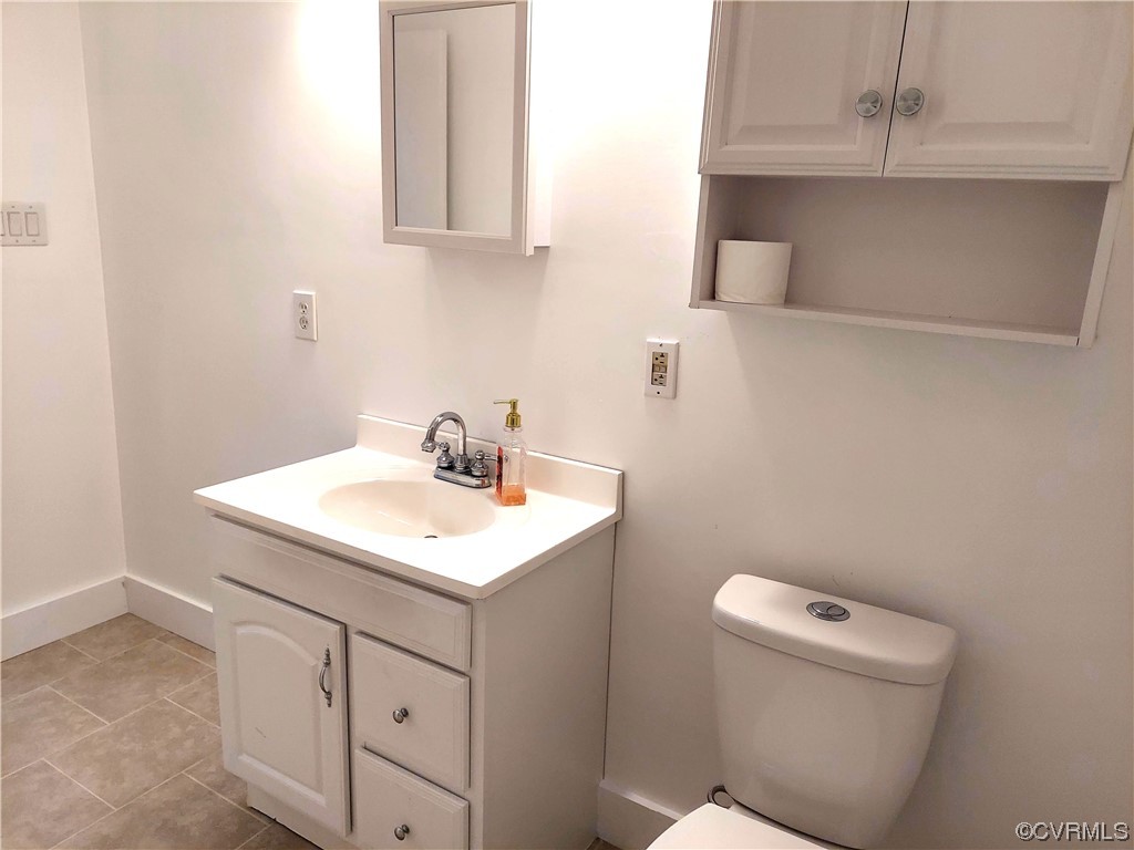 14413 Rivermont Road Chester, VA 23836 - Photo 13 of 21 a bathroom with a sink a toilet and a mirror
